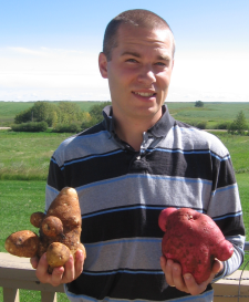 Dave holding a Russet & a Viking potato